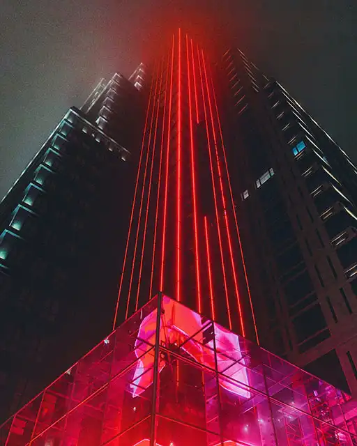 image of two parallel buildings with red lighting upward Tesla Solution